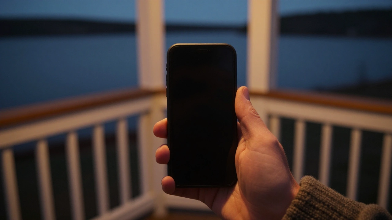 Hand holding a phone on a cottage porch for mobile casino play